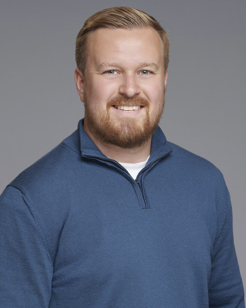 Professional business headshot of a man, photographed in a London studio with a neutral backdrop.