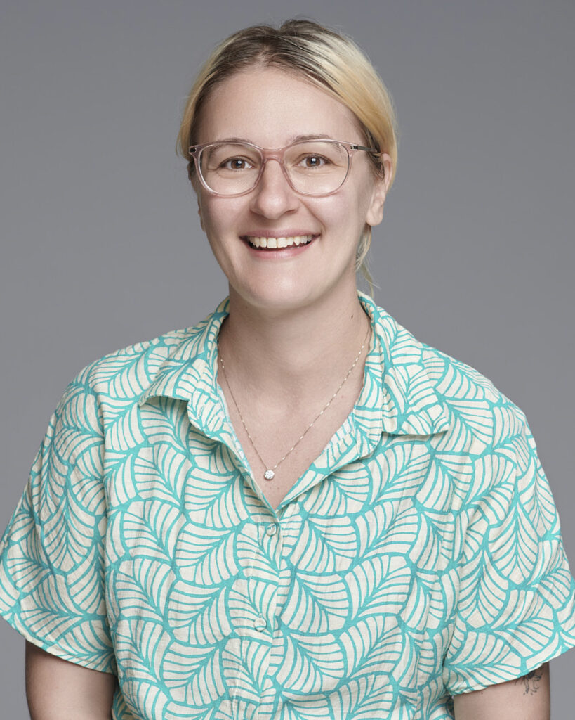 Professional business headshot of a woman working in the corporate creative industry, photographed in a London studio with a neutral backdrop.