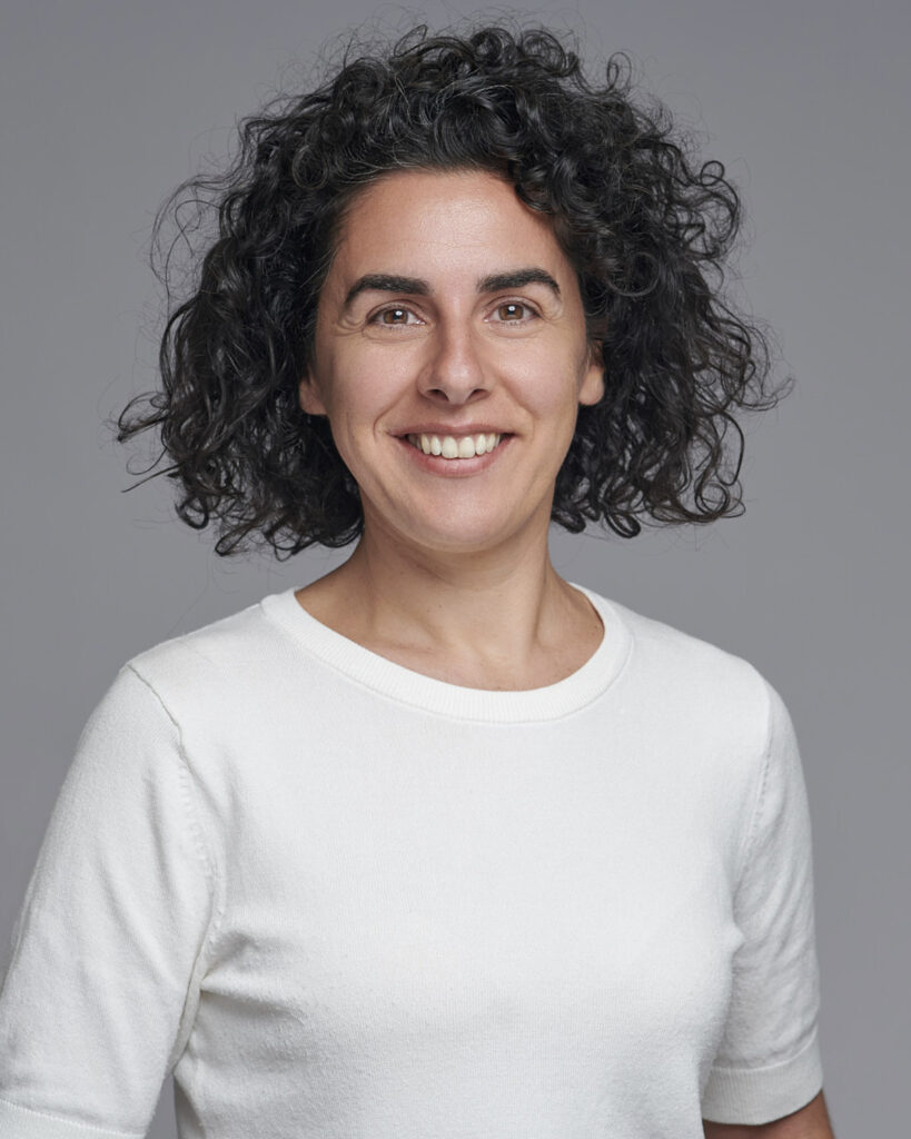 Professional business headshot of a woman working in the corporate creative industry, photographed in a London studio with a neutral backdrop.
