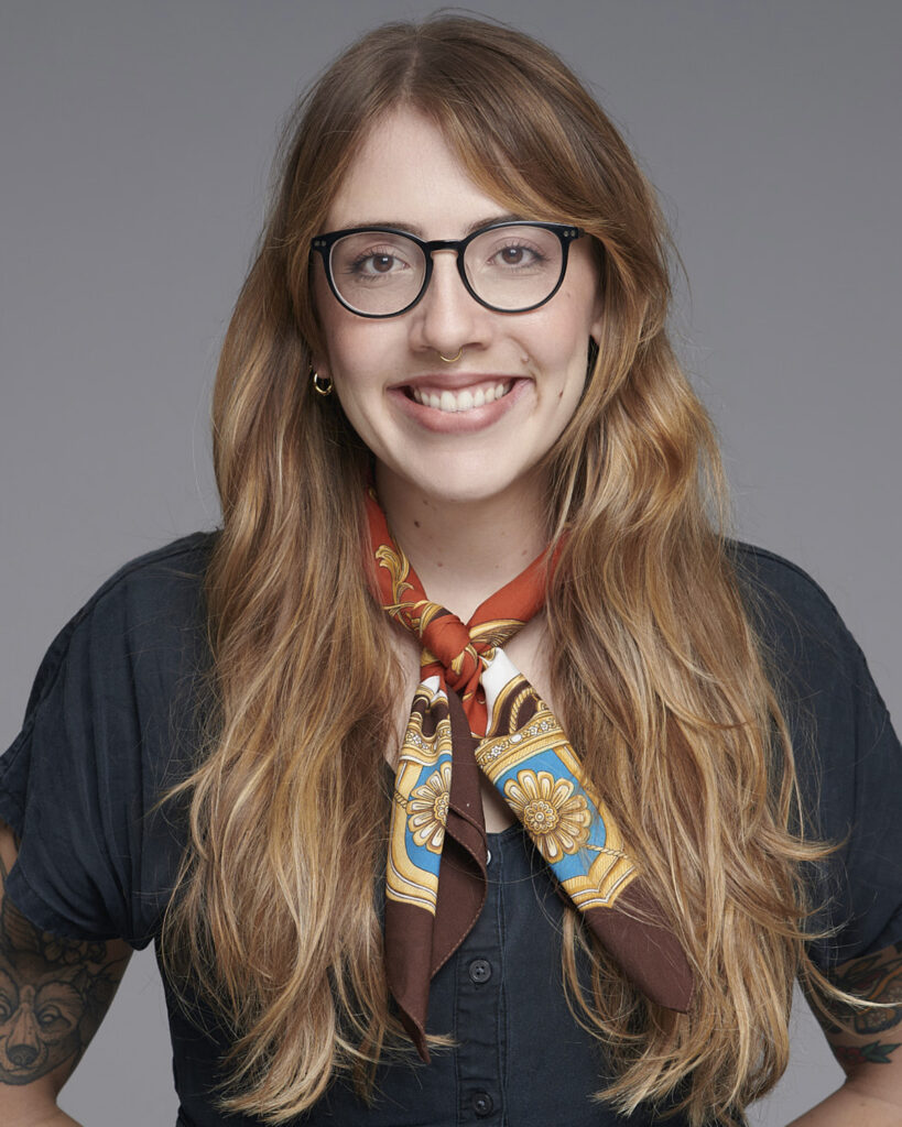 Professional business headshot of a woman working in the corporate creative industry, photographed in a London studio with a neutral backdrop.