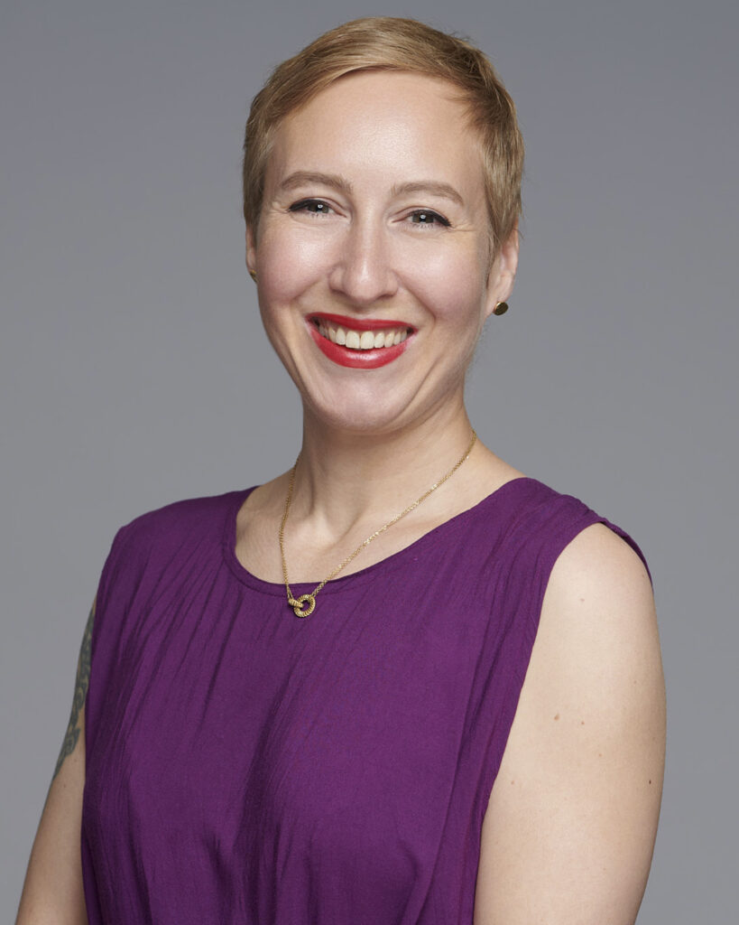 Professional business headshot of a woman working in the corporate creative industry, photographed in a London studio with a neutral backdrop.
