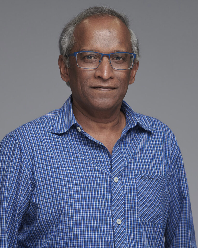 Professional business headshot of a man, photographed in a London studio with a neutral backdrop.