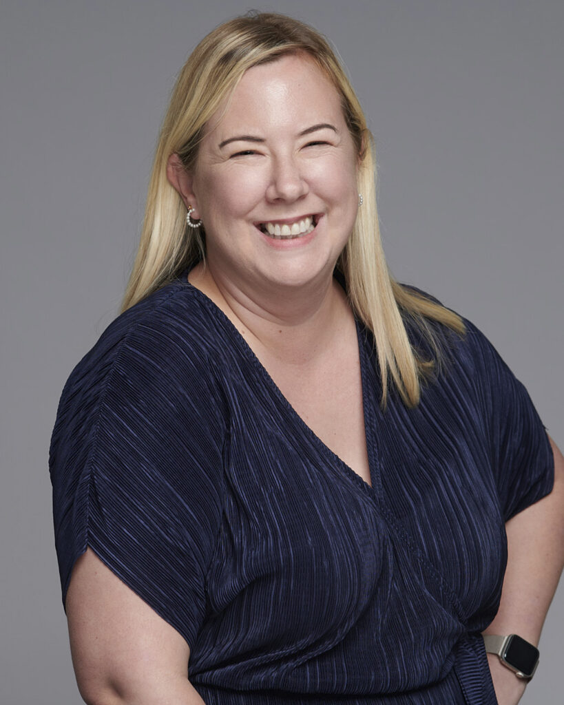 Professional business headshot of a woman working in the corporate industry, photographed in a London studio with a neutral backdrop.