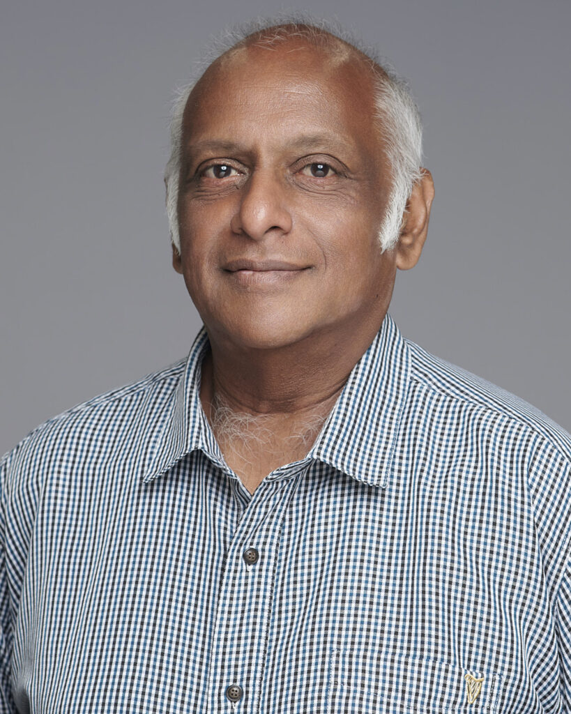Professional business headshot of a man, photographed in a London studio with a neutral backdrop.