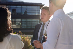 Charlie Walker of the London Stock Exchange in conversation during an investor rooftop drinks event – image by Collective Images